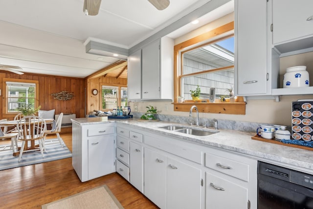 13 Atlantic Cir, Kennebunk, ME 04043 - kitchen featuring black dishwasher, a sink, light wood-style flooring, healthy amount of natural light, and wooden walls