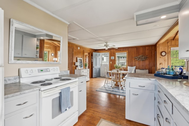 13 Atlantic Cir, Kennebunk, ME 04043 - kitchen with white electric range, wood walls, light countertops, a ceiling fan, and white cabinetry