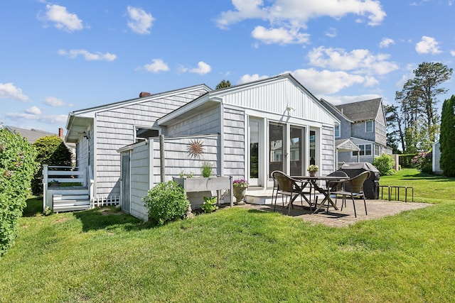 13 Atlantic Cir, Kennebunk, ME 04043 - rear view of house with a patio area and a lawn