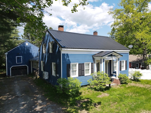 37 Enfield Rd, Lincoln, ME 04457 - view of front of house featuring a chimney, driveway, ac unit, and metal roof