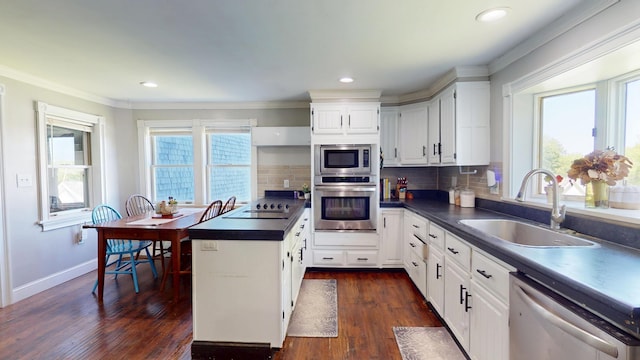 37 Enfield Rd, Lincoln, ME 04457 - kitchen with stainless steel appliances, a sink, dark countertops, ornamental molding, and white cabinets