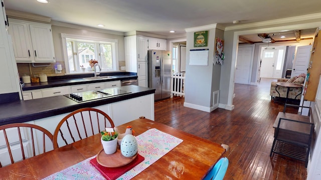 37 Enfield Rd, Lincoln, ME 04457 - dining space with ornamental molding, recessed lighting, dark wood finished floors, and baseboards