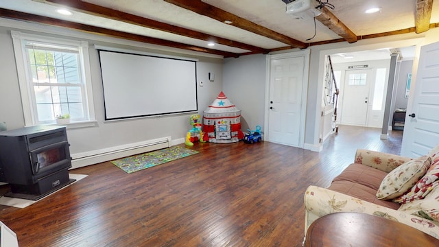 37 Enfield Rd, Lincoln, ME 04457 - home theater featuring baseboard heating, a wood stove, wood finished floors, beam ceiling, and recessed lighting