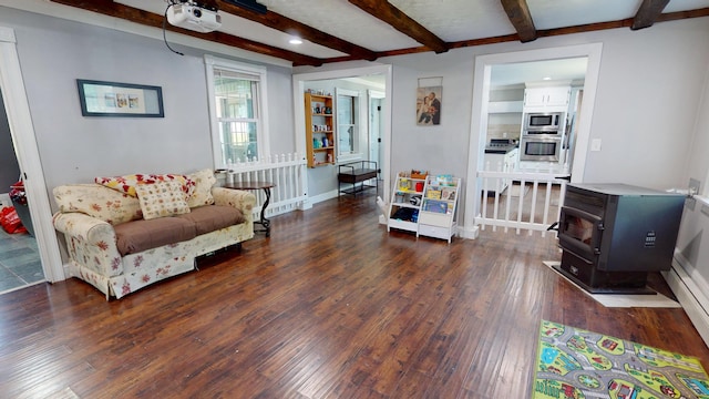 37 Enfield Rd, Lincoln, ME 04457 - living room with a wood stove, hardwood / wood-style flooring, beam ceiling, baseboards, and recessed lighting