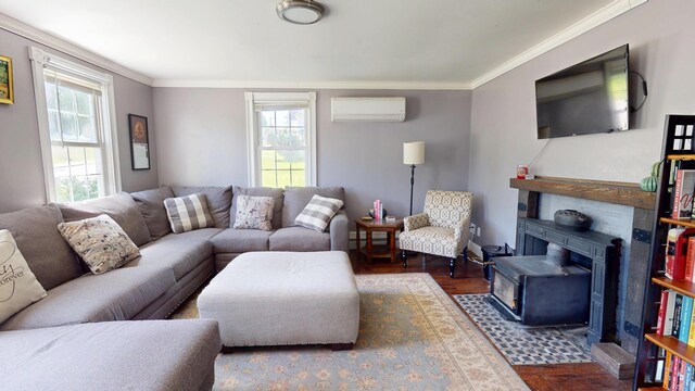 37 Enfield Rd, Lincoln, ME 04457 - living area with an AC wall unit, healthy amount of natural light, wood finished floors, a wood stove, and ornamental molding