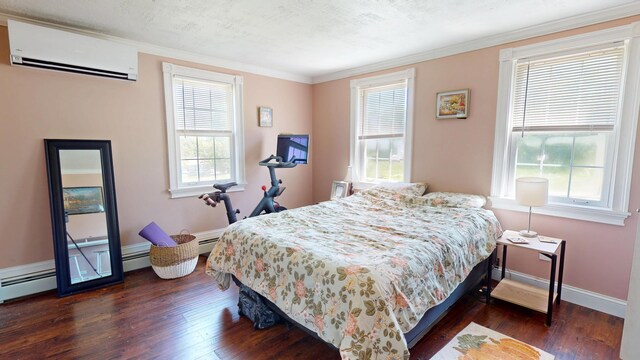 37 Enfield Rd, Lincoln, ME 04457 - bedroom featuring a wall unit AC, dark wood-type flooring, baseboards, and ornamental molding