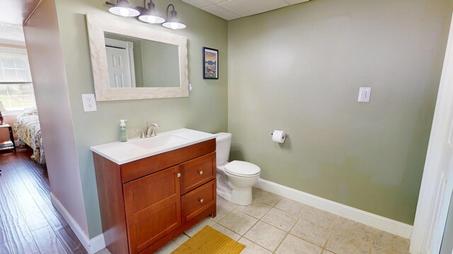 37 Enfield Rd, Lincoln, ME 04457 - bathroom with vanity, toilet, baseboards, and ensuite bathroom