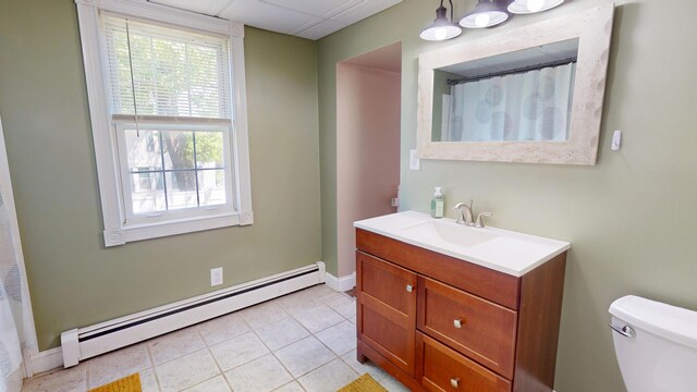 37 Enfield Rd, Lincoln, ME 04457 - full bath with baseboard heating, vanity, toilet, tile patterned flooring, and baseboards