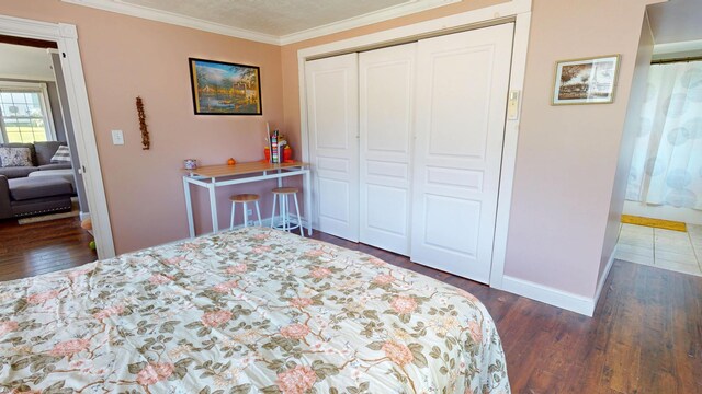 37 Enfield Rd, Lincoln, ME 04457 - bedroom featuring baseboards, a closet, wood finished floors, and ornamental molding