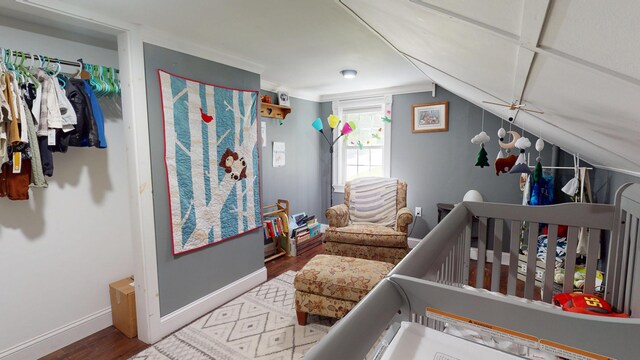 37 Enfield Rd, Lincoln, ME 04457 - bedroom featuring wood finished floors, a nursery area, baseboards, and vaulted ceiling