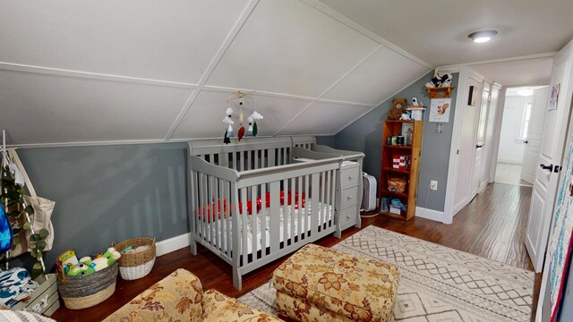37 Enfield Rd, Lincoln, ME 04457 - bedroom featuring wood finished floors, baseboards, a nursery area, and lofted ceiling