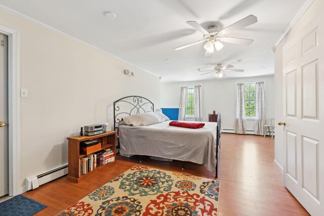 17 S Rd, Winthrop, ME 04364 - bedroom featuring a baseboard radiator, wood finished floors, ornamental molding, and ceiling fan