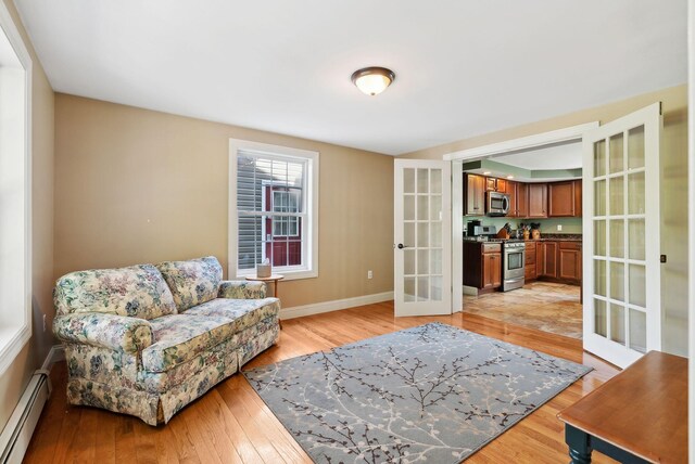 17 S Rd, Winthrop, ME 04364 - living area featuring french doors, a baseboard heating unit, and light wood-style flooring
