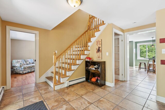 17 S Rd, Winthrop, ME 04364 - stairs featuring a baseboard heating unit, tile patterned floors, and baseboards