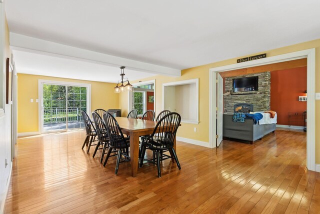 17 S Rd, Winthrop, ME 04364 - dining area featuring light wood-type flooring, a fireplace, baseboards, and a chandelier
