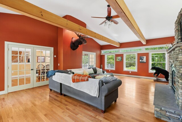 17 S Rd, Winthrop, ME 04364 - living area with french doors, beam ceiling, light wood finished floors, a fireplace, and ceiling fan
