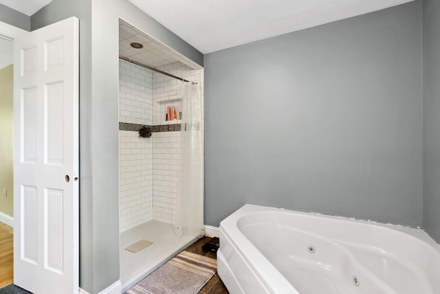17 S Rd, Winthrop, ME 04364 - bathroom featuring a stall shower, a tub with jets, and wood finished floors