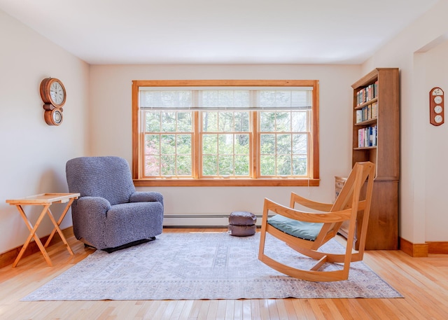 20 Ocean Side Ln, Bristol, ME 04554 - sitting room with healthy amount of natural light, a baseboard heating unit, and wood finished floors