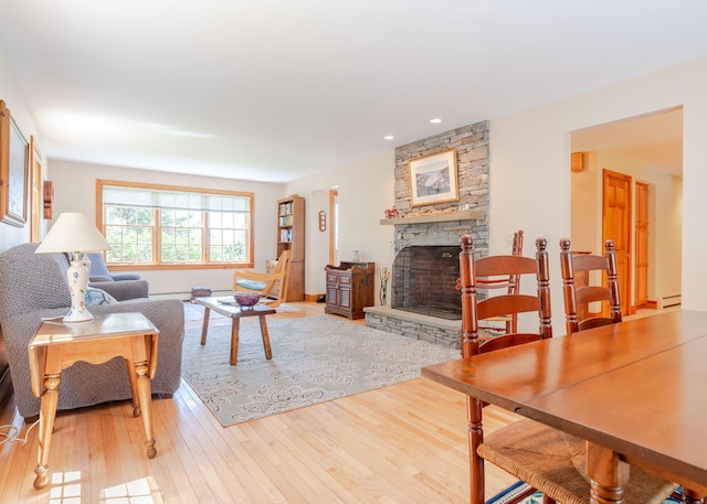 20 Ocean Side Ln, Bristol, ME 04554 - living area featuring wood finished floors, a fireplace, recessed lighting, baseboard heating, and a baseboard heating unit
