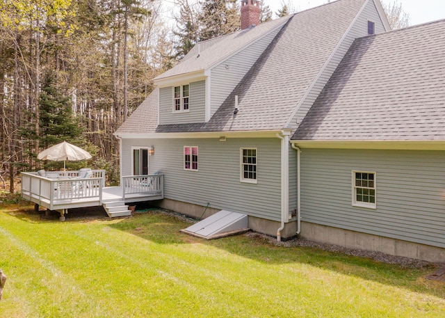 20 Ocean Side Ln, Bristol, ME 04554 - back of property featuring a shingled roof, a wooden deck, a yard, and a chimney