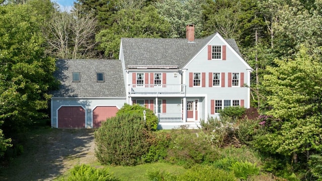 20 Ocean Side Ln, Bristol, ME 04554 - view of front of house with a balcony, a chimney, a shingled roof, dirt driveway, and a porch