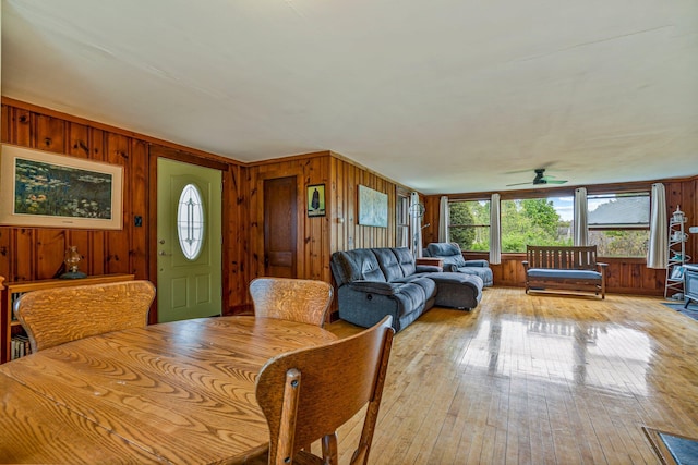 206 Sebago Lake Rd, Gorham, ME 04038 - dining area with wood walls, healthy amount of natural light, ceiling fan, and light wood finished floors