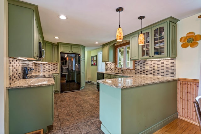 206 Sebago Lake Rd, Gorham, ME 04038 - kitchen featuring appliances with stainless steel finishes, green cabinetry, a sink, a peninsula, and backsplash