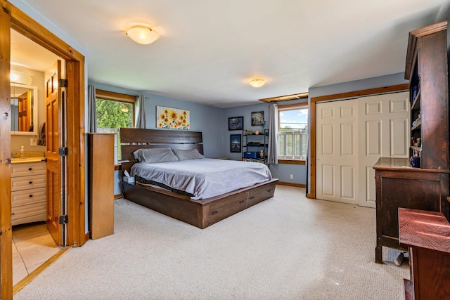 206 Sebago Lake Rd, Gorham, ME 04038 - bedroom with multiple windows, light carpet, and connected bathroom