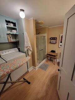 15 River Rd, Phillips, ME 04966 - bathroom with wood finished floors, a stall shower, independent washer and dryer, and baseboards