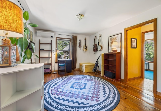 35 Salem Towne Rd, Southwest Harbor, ME 04679 - living area with a wall mounted air conditioner, hardwood / wood-style floors, and baseboards