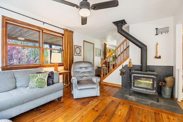 35 Salem Towne Rd, Southwest Harbor, ME 04679 - living room with wood-type flooring, a wood stove, a ceiling fan, and stairs
