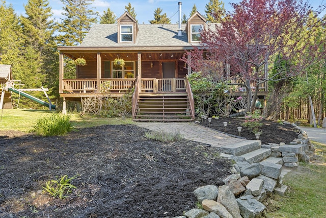 35 Salem Towne Rd, Southwest Harbor, ME 04679 - view of front of house with roof with shingles, stairway, a porch, and a playground