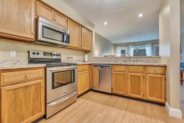 18 Smithwheel Rd Unit 21, Old Orchard Beach, ME 04064 - kitchen featuring appliances with stainless steel finishes, light wood finished floors, recessed lighting, and a sink