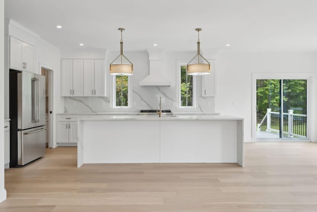 90 Running Hill Rd, Scarborough, ME 04074 - kitchen featuring high end fridge, custom exhaust hood, light countertops, white cabinetry, and recessed lighting