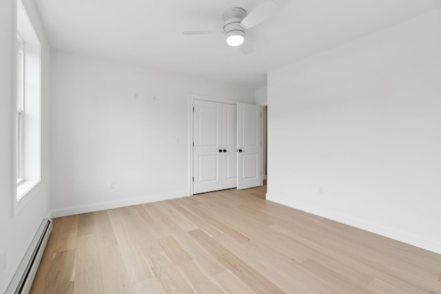 90 Running Hill Rd, Scarborough, ME 04074 - unfurnished room with a baseboard heating unit, light wood-style floors, ceiling fan, and baseboards