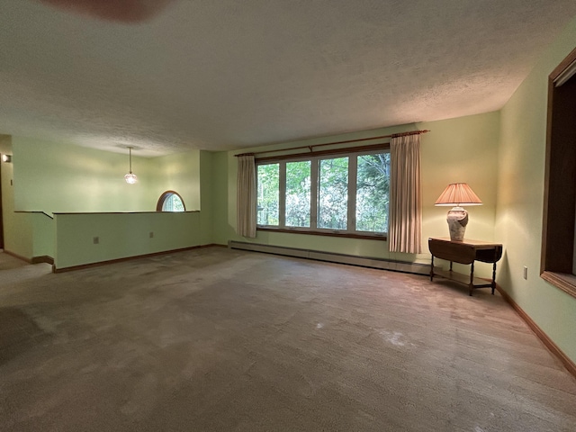 96 Pamela Dr, Winthrop, ME 04364 - unfurnished living room featuring carpet floors, a textured ceiling, baseboards, and a baseboard heating unit