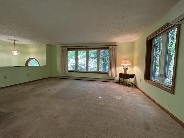 96 Pamela Dr, Winthrop, ME 04364 - carpeted spare room with a textured ceiling, a baseboard heating unit, and baseboards