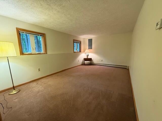 96 Pamela Dr, Winthrop, ME 04364 - empty room with carpet, a textured ceiling, a baseboard radiator, baseboards, and electric panel