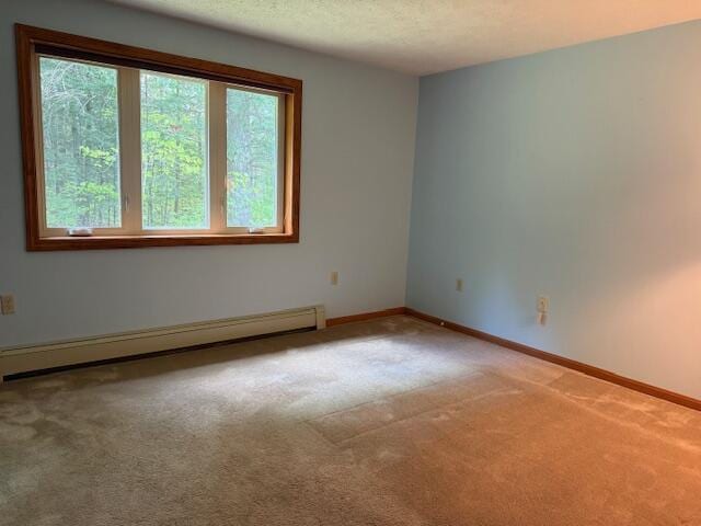 96 Pamela Dr, Winthrop, ME 04364 - empty room featuring a baseboard radiator, plenty of natural light, light carpet, baseboards, and a textured ceiling