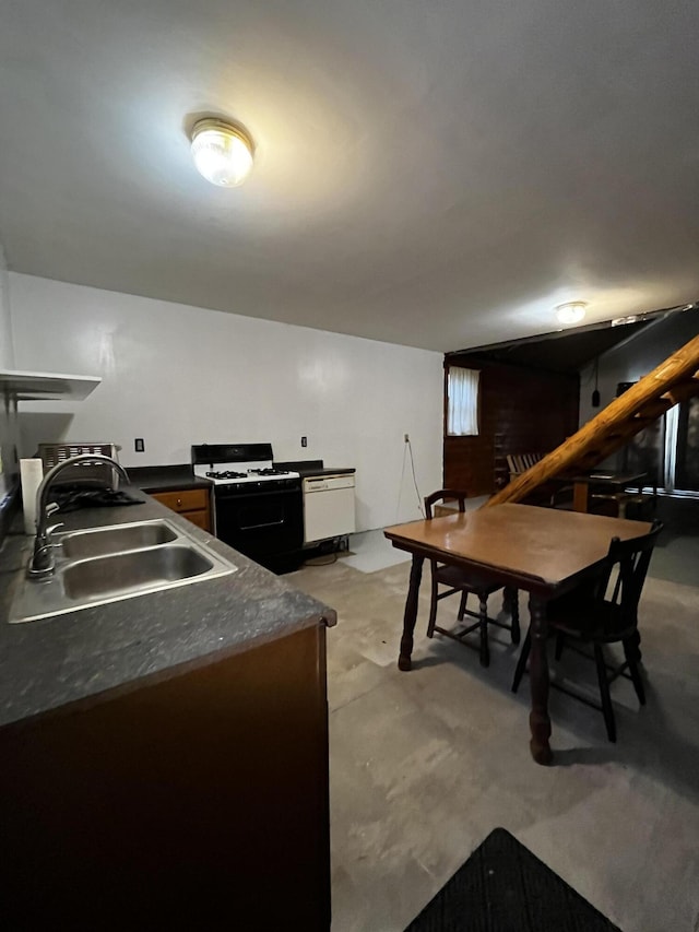 371 Carding Machine Rd, Bowdoinham, ME 04008 - kitchen featuring gas range oven, a sink, dark countertops, and concrete floors