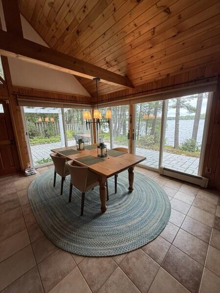 27 Chickadee Ln, Naples, ME 04055 - sunroom / solarium with vaulted ceiling, a baseboard radiator, plenty of natural light, and a chandelier