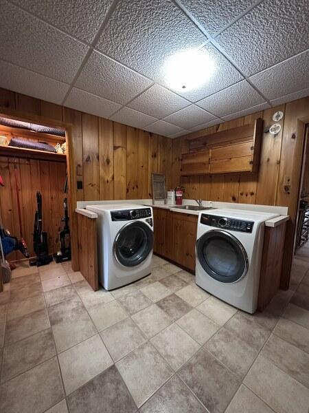 27 Chickadee Ln, Naples, ME 04055 - laundry room with washer / clothes dryer, cabinet space, and wooden walls