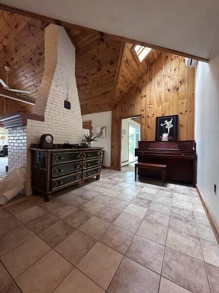 27 Chickadee Ln, Naples, ME 04055 - bedroom featuring a skylight, wooden walls, and high vaulted ceiling