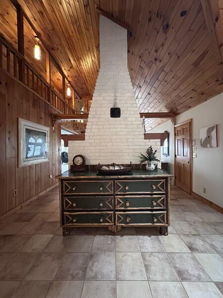 27 Chickadee Ln, Naples, ME 04055 - bedroom with wood ceiling, baseboards, multiple windows, lofted ceiling, and brick wall