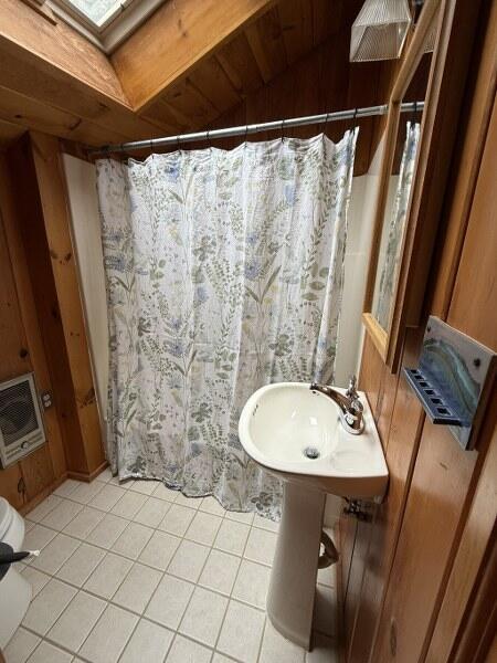 27 Chickadee Ln, Naples, ME 04055 - bathroom with tile patterned flooring, a skylight, heating unit, and curtained shower