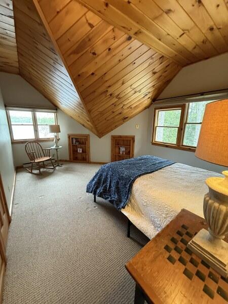 27 Chickadee Ln, Naples, ME 04055 - bedroom with lofted ceiling, carpet floors, multiple windows, and wooden ceiling