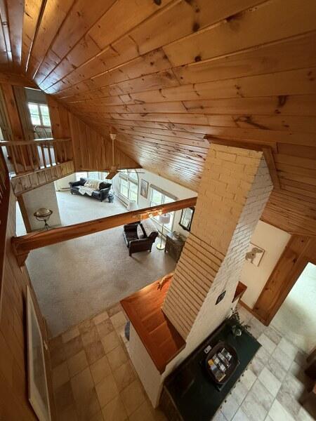 27 Chickadee Ln, Naples, ME 04055 - interior space with vaulted ceiling, wood walls, tile patterned floors, and wood ceiling