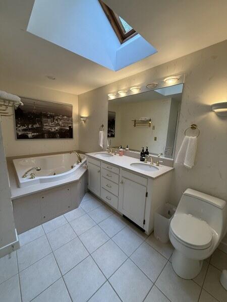 27 Chickadee Ln, Naples, ME 04055 - bathroom with a skylight, tile patterned flooring, toilet, and a whirlpool tub