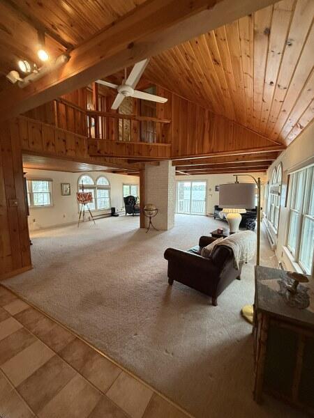 27 Chickadee Ln, Naples, ME 04055 - tiled bedroom featuring wood ceiling, high vaulted ceiling, wood walls, and carpet