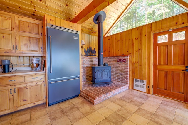 27 Chickadee Ln, Naples, ME 04055 - kitchen with built in refrigerator, lofted ceiling, a wood stove, wooden walls, and wooden ceiling